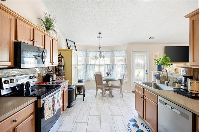 102 Autumn Brooke Trl, Dallas, GA 30157 - kitchen featuring appliances with stainless steel finishes, a sink, a chandelier, decorative backsplash, and hanging light fixtures