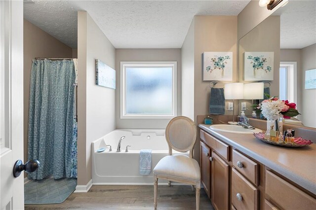 102 Autumn Brooke Trl, Dallas, GA 30157 - full bathroom with wood finished floors, a textured ceiling, vanity, a bath, and a shower with shower curtain