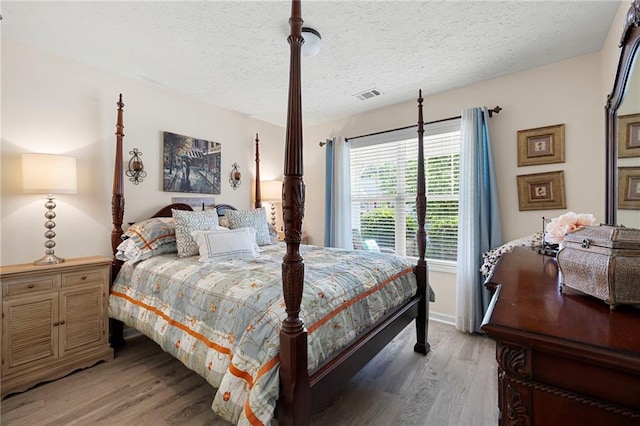 102 Autumn Brooke Trl, Dallas, GA 30157 - bedroom featuring light wood-style floors and a textured ceiling