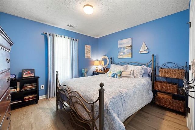 102 Autumn Brooke Trl, Dallas, GA 30157 - bedroom featuring a textured ceiling, wood finished floors, and baseboards