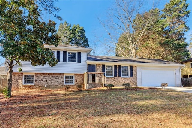 tri-level home featuring a garage and a front lawn