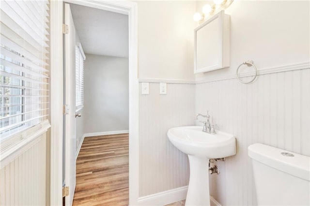 bathroom with hardwood / wood-style floors and toilet