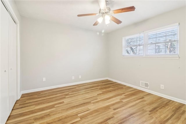 unfurnished bedroom with ceiling fan, a closet, and light wood-type flooring