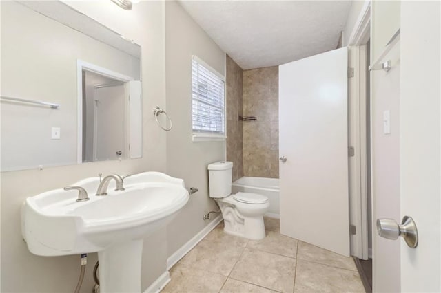 full bathroom featuring tiled shower / bath, sink, tile patterned floors, and toilet