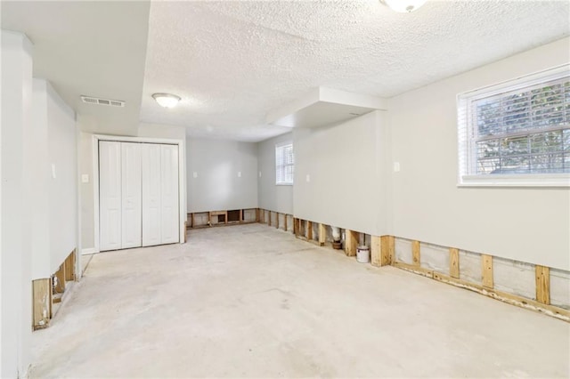 basement featuring a textured ceiling