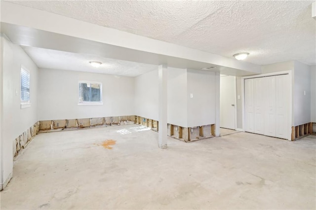 basement featuring a textured ceiling