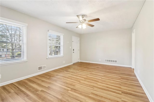 spare room featuring ceiling fan and light wood-type flooring