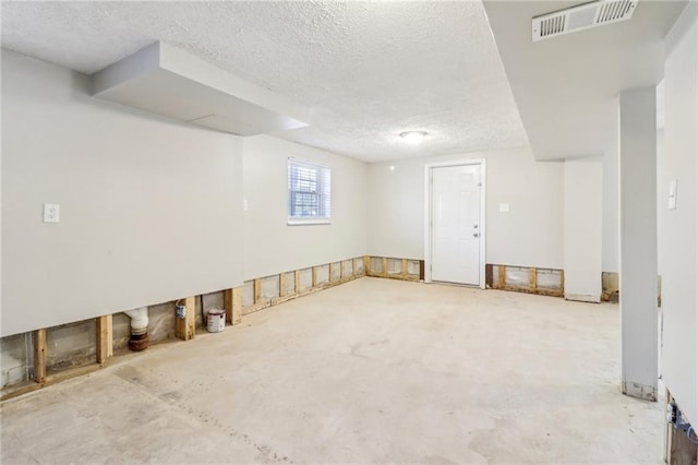 basement featuring a textured ceiling