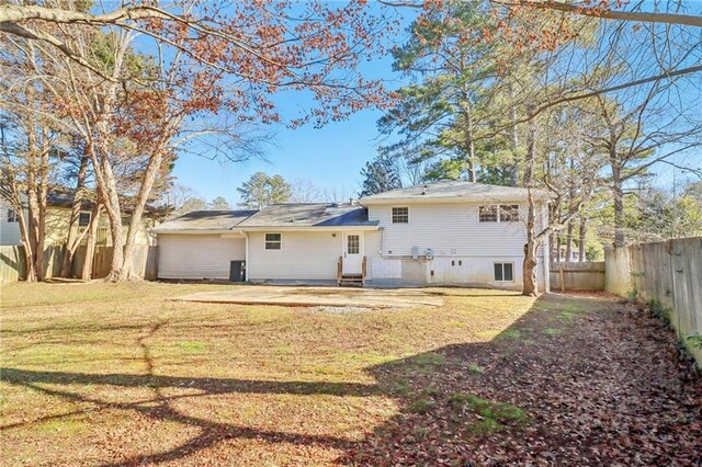 back of house with a yard and a patio area