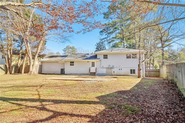 rear view of property with a patio and a lawn