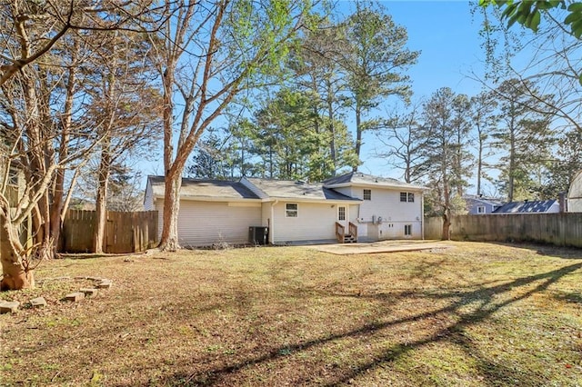 rear view of property with a patio and a lawn