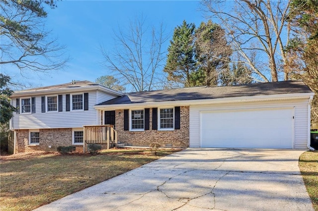 tri-level home with a garage and a front lawn