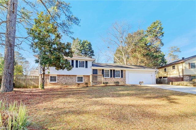 tri-level home featuring a garage and a front lawn