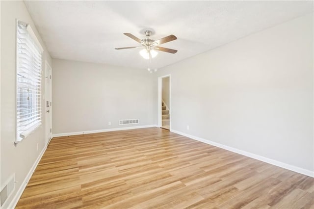 empty room featuring ceiling fan and light wood-type flooring