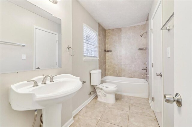 kitchen featuring sink, white cabinetry, light tile patterned floors, stainless steel appliances, and light stone countertops