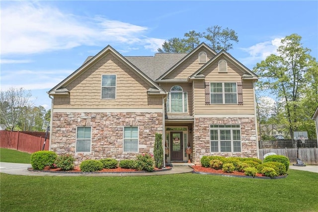 5143 Olive Branch Cir, Powder Springs, GA 30127 - craftsman house with stone siding, fence, and a front yard