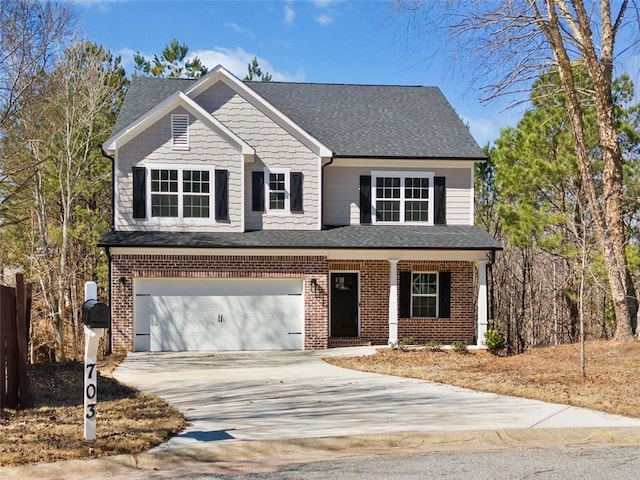 view of front of house with driveway, roof with shingles, an attached garage, covered porch, and brick siding