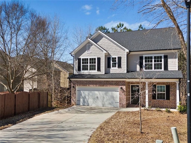 view of front of house featuring a garage, concrete driveway, brick siding, and fence