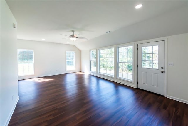 unfurnished living room featuring dark wood-type flooring, ceiling fan, and vaulted ceiling