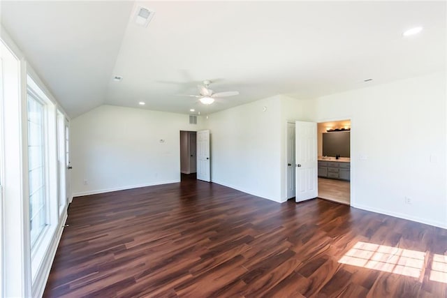 unfurnished bedroom featuring vaulted ceiling, ceiling fan, dark hardwood / wood-style flooring, and connected bathroom