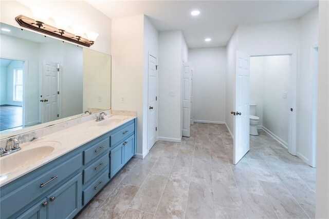 bathroom with washer and clothes dryer and vanity