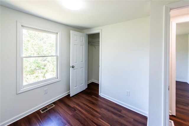 unfurnished room featuring dark hardwood / wood-style flooring