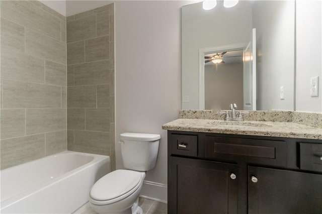 bathroom featuring toilet, vanity, a ceiling fan, and baseboards