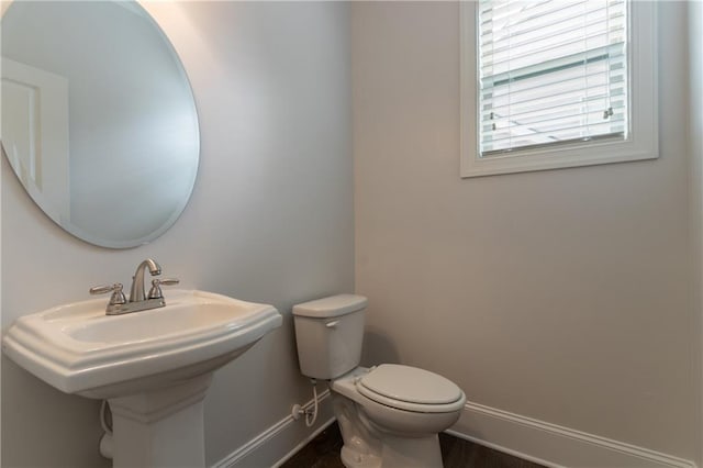 bathroom featuring baseboards and toilet