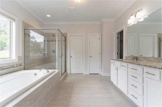 bathroom featuring a shower stall, healthy amount of natural light, a bath, vanity, and ornamental molding