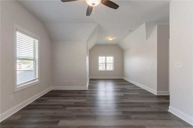bonus room featuring vaulted ceiling, ceiling fan, dark wood finished floors, and baseboards