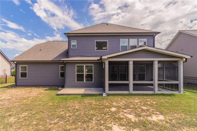 back of property featuring a patio area, a sunroom, and a shingled roof