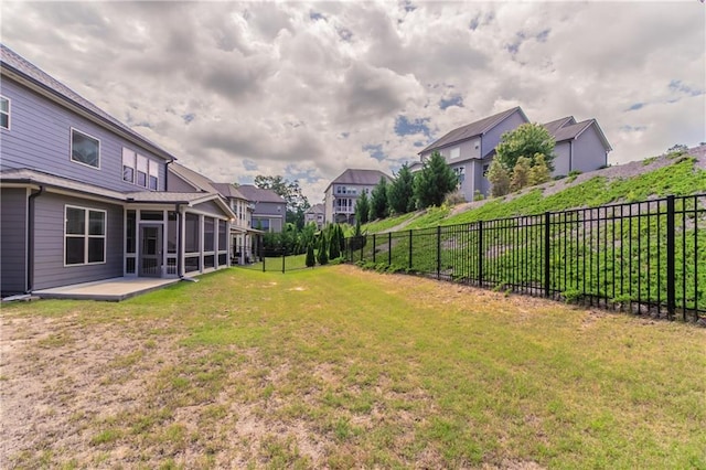 view of yard featuring a sunroom and a residential view