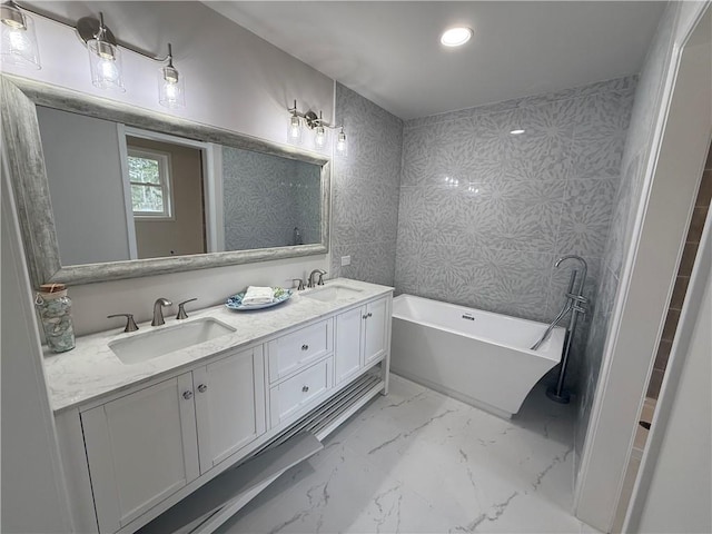 bathroom with vanity and a tub