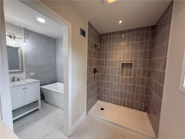 bathroom featuring vanity and shower with separate bathtub