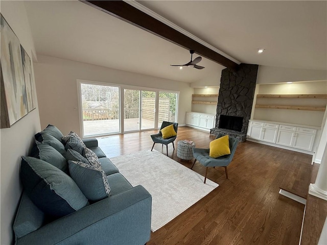 living room with vaulted ceiling with beams, dark wood-type flooring, a fireplace, and ceiling fan