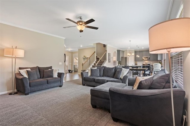 carpeted living room with stairway, a ceiling fan, ornamental molding, and baseboards