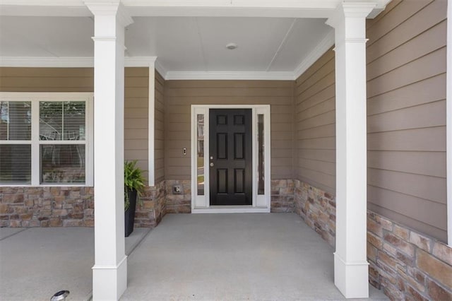 entrance to property with stone siding and covered porch