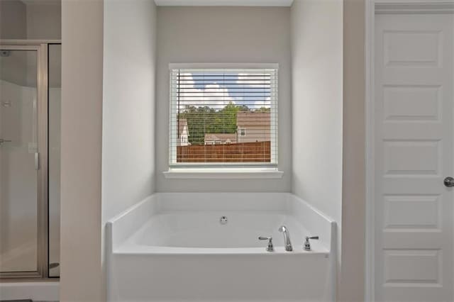 full bath with a garden tub and a shower stall