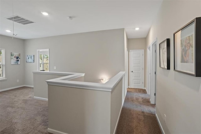 corridor featuring carpet, baseboards, and recessed lighting