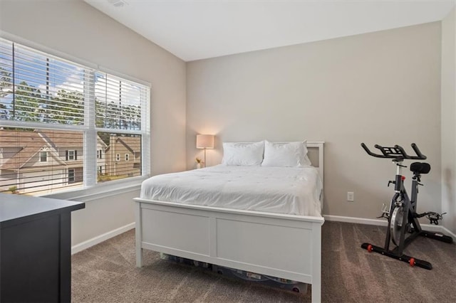 carpeted bedroom featuring baseboards