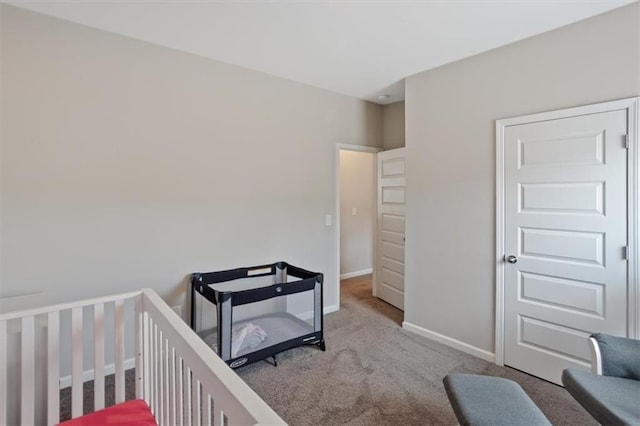 carpeted bedroom featuring baseboards