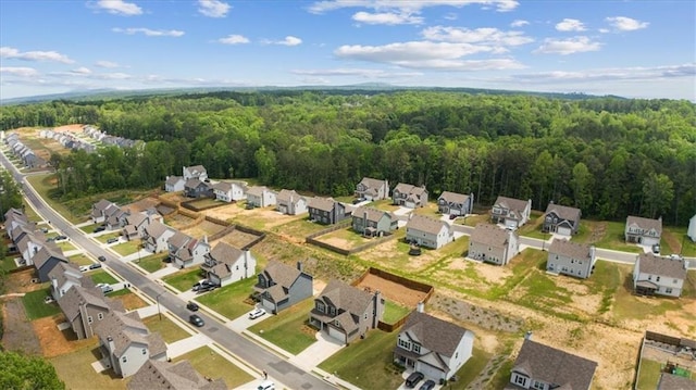 aerial view of residential area with a heavily wooded area