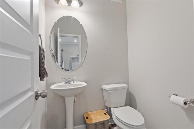 half bath with toilet and a sink