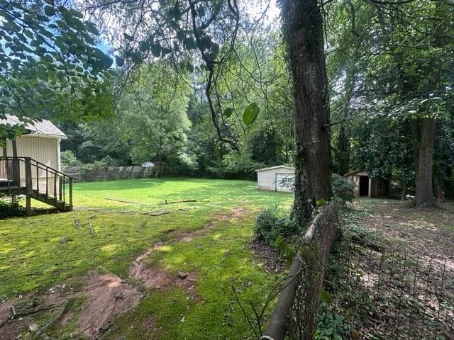 400 Jon Scott Dr, Alpharetta, GA 30009 - view of green lawn featuring a storage shed and stairway