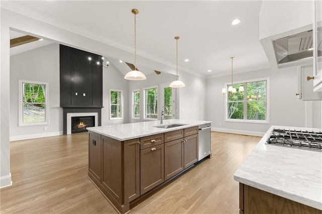 4860 Grandview Ct, Flowery Branch, GA 30542 - kitchen with a large fireplace, open floor plan, stainless steel appliances, light wood finished floors, and an island with sink