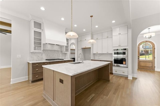 4860 Grandview Ct, Flowery Branch, GA 30542 - kitchen with stainless steel double oven, arched walkways, backsplash, white cabinetry, and recessed lighting