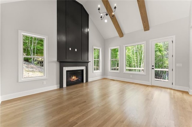4860 Grandview Ct, Flowery Branch, GA 30542 - unfurnished living room featuring a chandelier, high vaulted ceiling, a large fireplace, light wood-style floors, and beamed ceiling