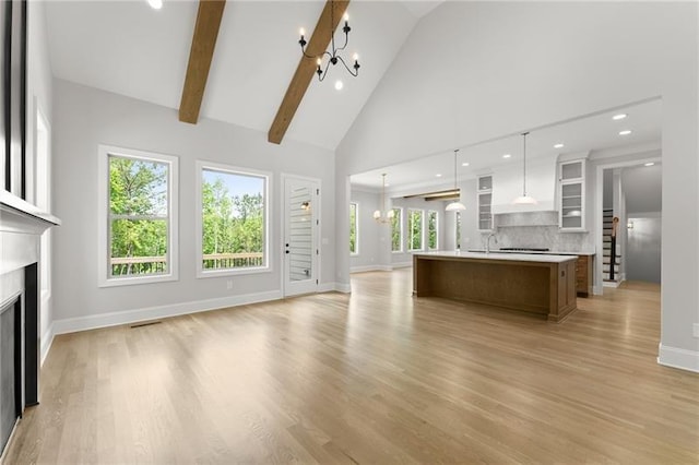 4860 Grandview Ct, Flowery Branch, GA 30542 - unfurnished living room with a chandelier, a fireplace, high vaulted ceiling, light wood-type flooring, and recessed lighting