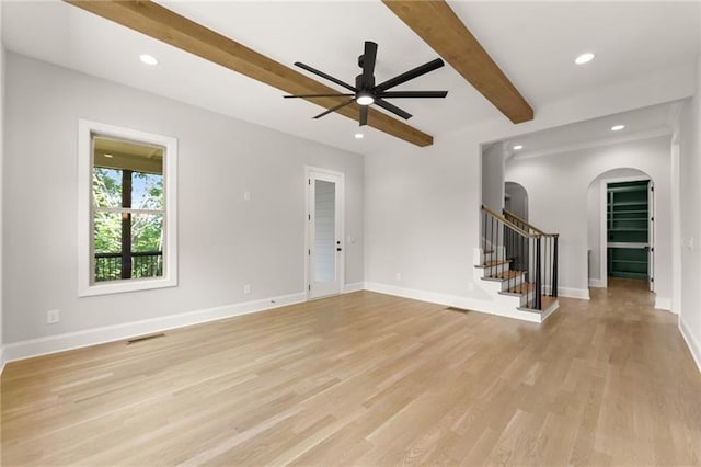 4860 Grandview Ct, Flowery Branch, GA 30542 - empty room with arched walkways, beam ceiling, ceiling fan, light wood finished floors, and stairway