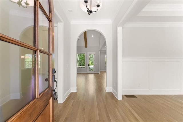 4860 Grandview Ct, Flowery Branch, GA 30542 - entrance foyer with arched walkways, light wood finished floors, crown molding, a decorative wall, and beamed ceiling